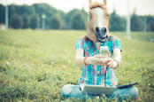 Woman in horse mask takes a selfie. Photo by Shutterstock