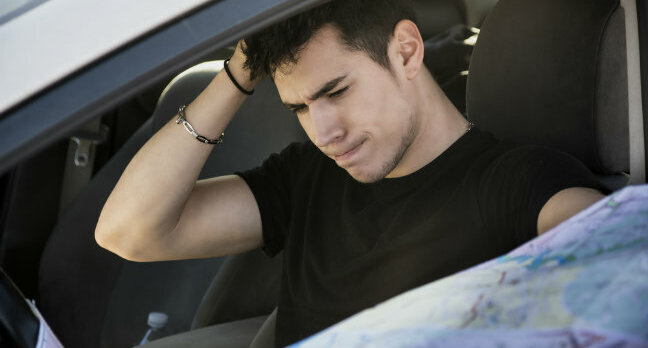 Confused lost-looking driver with map. Photo by SHutterstock