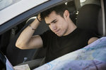 Confused lost-looking driver with map. Photo by SHutterstock