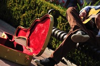 Street musician busks for coins. Photo by Shutterstock