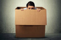 A person hiding in a box