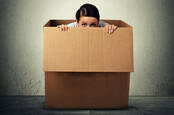 A person hiding in a box