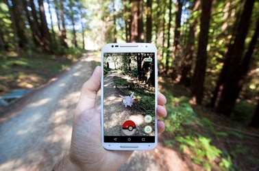 The hit augmented reality smartphone app "Pokemon GO" shows a Pokemon encounter overlain on a real world trail in the forest in Santa Cruz, California. Photo by Matthew Corley for Shutterstock. EDITORIAL USE ONLY!. 