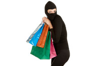 Woman in balaclava with shopping bags. Photo by Shutterstock
