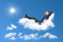 Man relaxes, stretches out, outs his feet up on a cloud.... Fun but hammy stock pic. Photo by Shutterstock