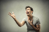Comically sad tearful man doing fake-looking wail of despair. Photo by Shutterstock