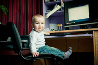 Baby on a computer. Photo by Shutterstock