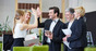 Colleague high fives in the office. Photo by Shutterstock
