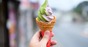 Hand holds green tea and sweetpotato soft serve ice cream cone. Looks delicious if you didn't know about the flavours though. Photo by Shutterstock