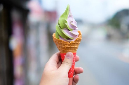 Hand holds green tea and sweetpotato soft serve ice cream cone. Looks delicious if you didn't know about the flavours though. Photo by Shutterstock