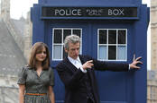  peter capaldi as the Doctor and jenna coleman as the assistant in front of the Tardis - from bbc kids fantasy series Doctor Who
