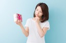 Thanks, I suppose. Woman contemplates unwanted gift. Photo by Shutterstock
