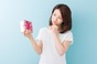 Thanks, I suppose. Woman contemplates unwanted gift. Photo by Shutterstock