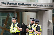 Police Scotland employees stand outside the Scottish Parliament. Pic: Shutterstock
