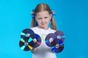 Little girl holds bluray discs up. photo by shutterstock