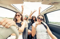Women having fun in convertible (no seatbelts though). Photo by shutterstock