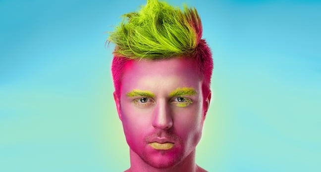 Handsome man has fuchsia-painted skin. Photo by Shutterstock