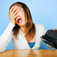 An upset woman with an empty wallet