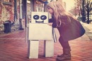 Little girl embraces robot. Photo by Shutterstock