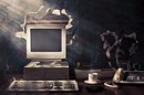 Vintage PC with floppy drive, dot matrix printer and old school desk phone, steaming coffee: a still life. photo by Shutterstock