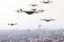 Drones hover above a smart city. Photo by shutterstock