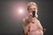 John McAfee with gun