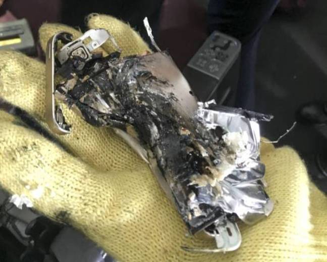 The crushed personal electronic device (PED) wedged tightly in the seat mechanism found on QF 7