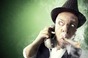 PRIVATE investigator on the phone, smoking a cigar, looks around suspiciously. Photo by Shutterstock