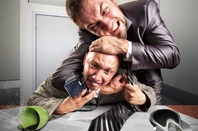 Two angry businessmen fighting over agreement signing. Coffee is spilled. .Photo by Shutterstock