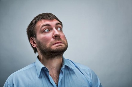 Man winces in terror and shock after something unexpectedly horrible happens to him. Photo by Shutterstock