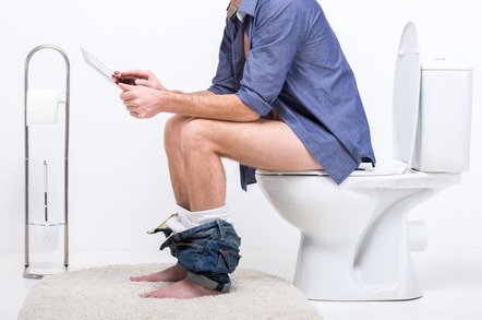 man reads tablet on the toilet. Photo by Shutterstock