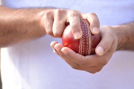 Bowler holds cricket ball. Photo by SHutterstock
