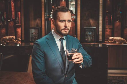 Well-dressed man drinks whisky in expensive flat. Photo by Shutterstock