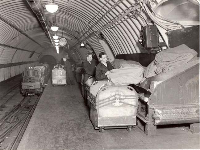 Workers loading mail sacks onto Mail Rail 1935 photo The Postal Museum and Mail Rail