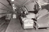 Workers loading mail sacks onto Mail Rail 1935 photo The Postal Museum and Mail Rail