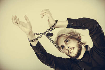 A man with his hands chained up