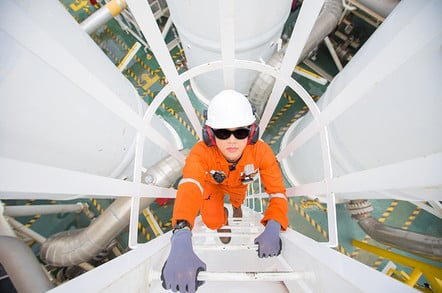 Oil refinery - engineer checks fuel mix. Photo by Shutterstock