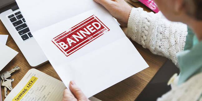 person opens letter reading 'banned'