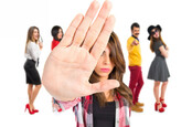 A group of hipster teens excludes the onlooker. Photo by shutterstock