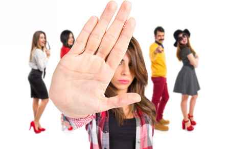 A group of hipster teens excludes the onlooker. Photo by shutterstock