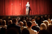 Standup comedian faces the crowd. Photo by shutterstock