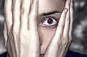 Person hides face in shocked anticipation of something horrible. Photo via shutterstock