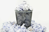 Wire wastepaper bin filled with scrunched up paper. Photo by Shutterstock