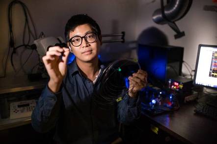 Graduate student Seongjun Park holds an example of a new flexible fiber
