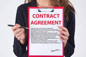 woman holds contract agreement to sign