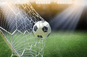Football goes into the net/ photo by shutterstock