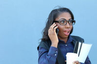 Woman with shocked expression answers cellphone. photo by Shutterstock