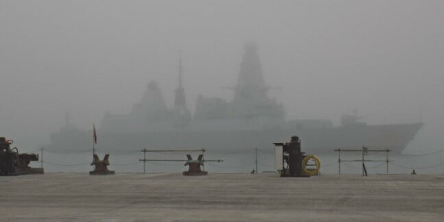 HMS Dragon emerging from the fog at HM Naval Base Portsmouth