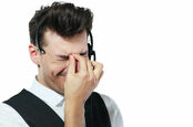 Call centre worker looks frustrated and unhappy. Photo by Shutterstock