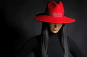 Woman in ret hat photo via Shutterstock